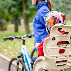 Mother and child enjoying a fun, safe bicycle ride together in a park.