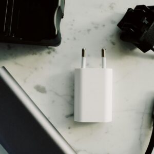 A collection of electronic adapters and chargers featuring USB-C and other connectors on a marble surface.